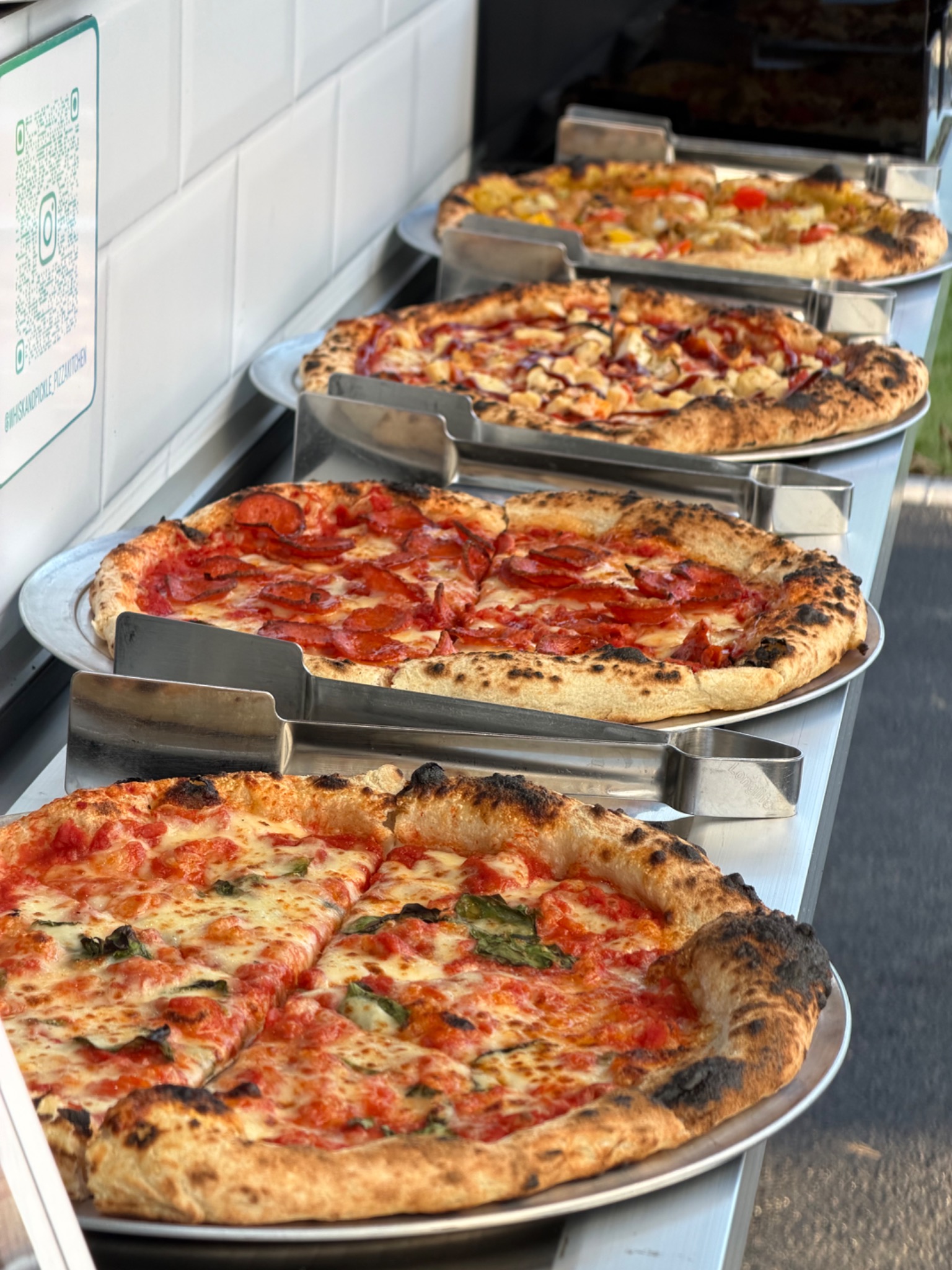 Whisk and Pickle pizzas freshly baked and ready on the buffet