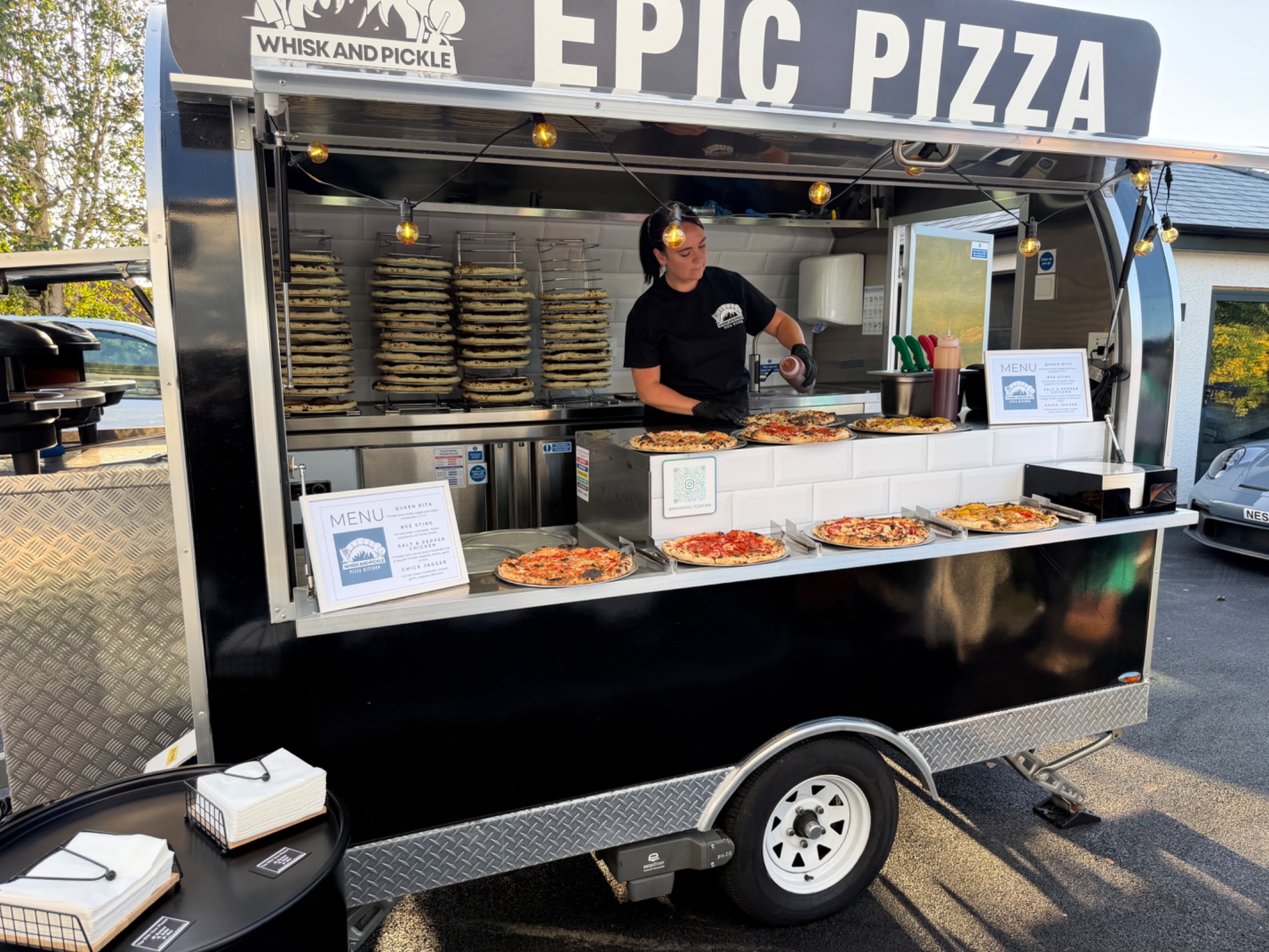Whisk And Pickle mobile pizza kitchen serving a pizza buffet
